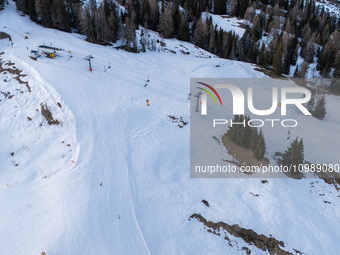 Aerial view of people skiing near Cortina d'Ampezzo, Italy, on February 4, 2024. A mild winter across Europe has resulted in several ski slo...