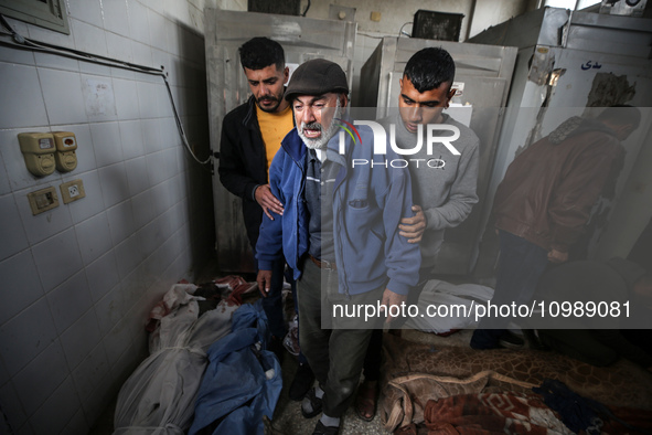 Palestinians are mourning their relatives, who were killed in an overnight Israeli strike on Deir al-Balah, during a mass funeral at the Al-...