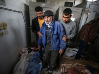 Palestinians are mourning their relatives, who were killed in an overnight Israeli strike on Deir al-Balah, during a mass funeral at the Al-...