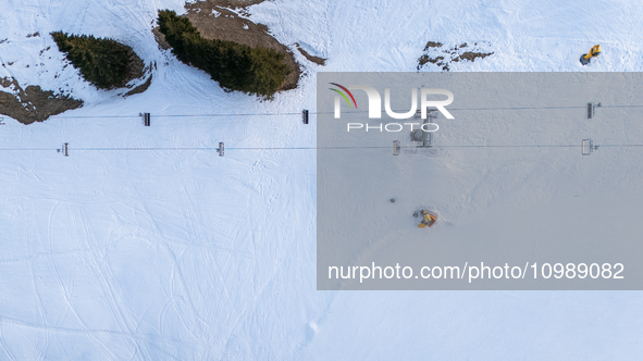 Aerial view of people skiing near Cortina d'Ampezzo, Italy, on February 4, 2024. A mild winter across Europe has resulted in several ski slo...