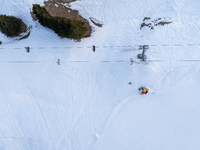 Aerial view of people skiing near Cortina d'Ampezzo, Italy, on February 4, 2024. A mild winter across Europe has resulted in several ski slo...