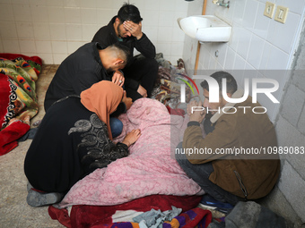 Palestinians are mourning their relatives, who were killed in an overnight Israeli strike on Deir al-Balah, during a mass funeral at the Al-...