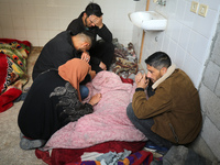 Palestinians are mourning their relatives, who were killed in an overnight Israeli strike on Deir al-Balah, during a mass funeral at the Al-...