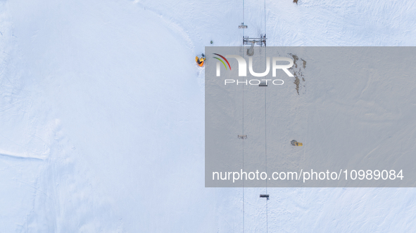 Aerial view of people skiing near Cortina d'Ampezzo, Italy, on February 4, 2024. A mild winter across Europe has resulted in several ski slo...