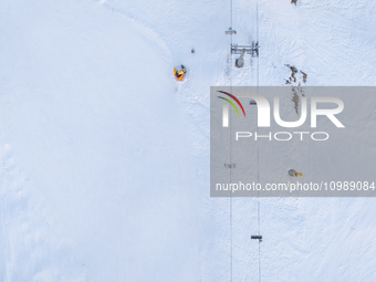 Aerial view of people skiing near Cortina d'Ampezzo, Italy, on February 4, 2024. A mild winter across Europe has resulted in several ski slo...