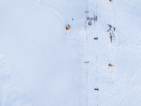 Aerial view of people skiing near Cortina d'Ampezzo, Italy, on February 4, 2024. A mild winter across Europe has resulted in several ski slo...