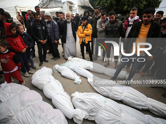 Palestinians are mourning their relatives, who were killed in an overnight Israeli strike on Deir al-Balah, during a mass funeral at the Al-...