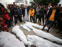 Palestinians are mourning their relatives, who were killed in an overnight Israeli strike on Deir al-Balah, during a mass funeral at the Al-...