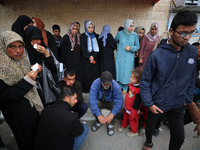 Palestinians are mourning their relatives, who were killed in an overnight Israeli strike on Deir al-Balah, during a mass funeral at the Al-...