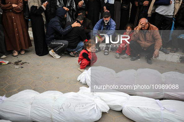 Palestinians are mourning their relatives, who were killed in an overnight Israeli strike on Deir al-Balah, during a mass funeral at the Al-...