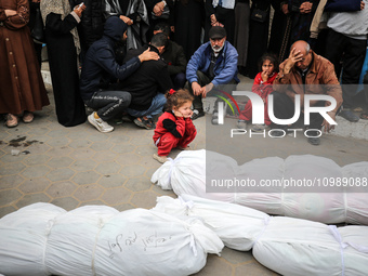 Palestinians are mourning their relatives, who were killed in an overnight Israeli strike on Deir al-Balah, during a mass funeral at the Al-...