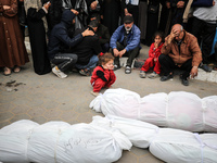 Palestinians are mourning their relatives, who were killed in an overnight Israeli strike on Deir al-Balah, during a mass funeral at the Al-...