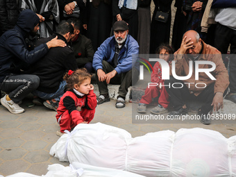 Palestinians are mourning their relatives, who were killed in an overnight Israeli strike on Deir al-Balah, during a mass funeral at the Al-...