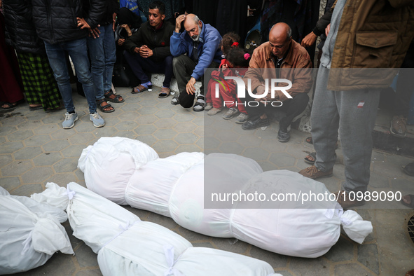 Palestinians are mourning their relatives, who were killed in an overnight Israeli strike on Deir al-Balah, during a mass funeral at the Al-...