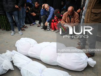 Palestinians are mourning their relatives, who were killed in an overnight Israeli strike on Deir al-Balah, during a mass funeral at the Al-...