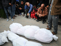 Palestinians are mourning their relatives, who were killed in an overnight Israeli strike on Deir al-Balah, during a mass funeral at the Al-...