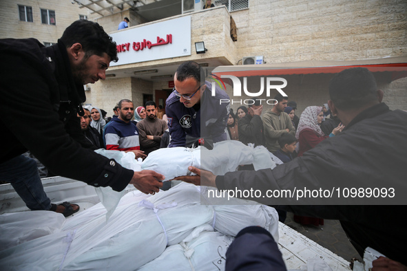 Palestinians are mourning their relatives, who were killed in an overnight Israeli strike on Deir al-Balah, during a mass funeral at the Al-...