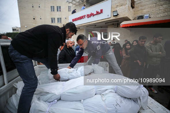 Palestinians are mourning their relatives, who were killed in an overnight Israeli strike on Deir al-Balah, during a mass funeral at the Al-...