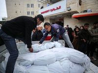 Palestinians are mourning their relatives, who were killed in an overnight Israeli strike on Deir al-Balah, during a mass funeral at the Al-...