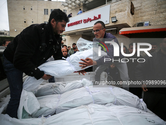 Palestinians are mourning their relatives, who were killed in an overnight Israeli strike on Deir al-Balah, during a mass funeral at the Al-...