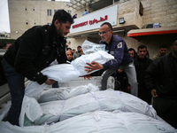 Palestinians are mourning their relatives, who were killed in an overnight Israeli strike on Deir al-Balah, during a mass funeral at the Al-...