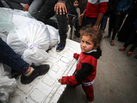 Palestinians are mourning their relatives, who were killed in an overnight Israeli strike on Deir al-Balah, during a mass funeral at the Al-...