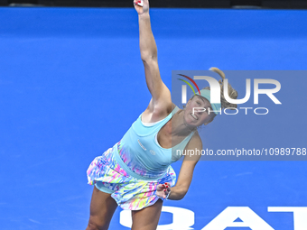 Magdalena Frech of Poland is in action during her first-round match against Victoria Azarenka of Belarus at the WTA 1000-Qatar TotalEnergies...