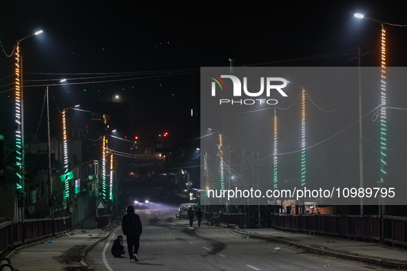 Kashmiri people are shooting videos as the bridge is being illuminated with the Tri-Color (Indian National Flag colors) in Baramulla, Jammu...