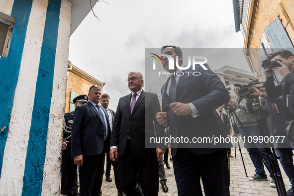 Constantinos Yiorkadjis and Frank-Walter Steinmeier are standing in front of an unmanned outpost in Nicosia, Cyprus, on February 12, 2024. T...