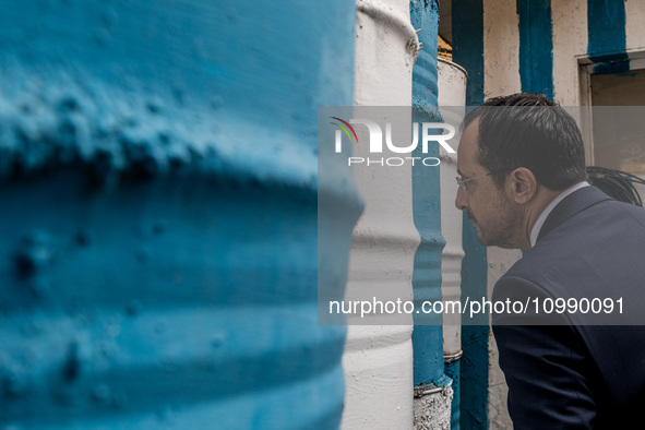 Nikos Christodoulides is looking through the barricade to the occupied part of Nicosia, Cyprus, on February 12, 2024. The President of Germa...