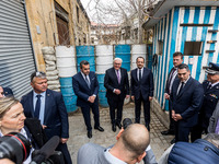 Constantinos Yiorkadjis, Frank-Walter Steinmeier, and Nikos Christodoulides are posing in front of a barricade in Nicosia, Cyprus, on Februa...