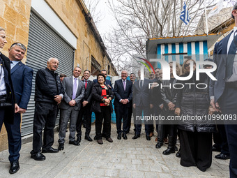 Constantinos Yiorkadjis, Frank-Walter Steinmeier, and Nikos Christodoulides are posing in front of a barricade in Nicosia, Cyprus, on Februa...