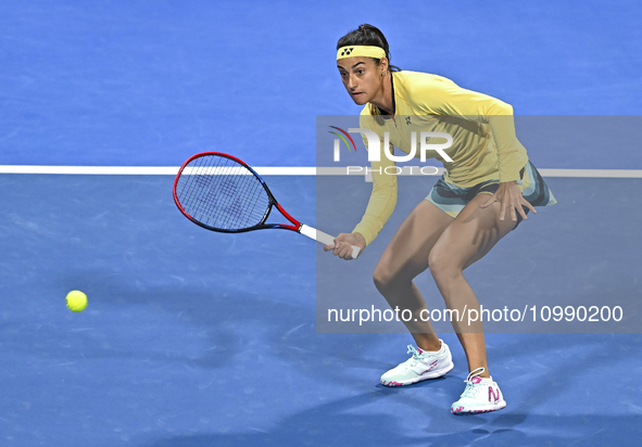 Caroline Garcia of France is in action during her first-round match against Naomi Osaka of Japan at the WTA 1000-Qatar TotalEnergies Open te...