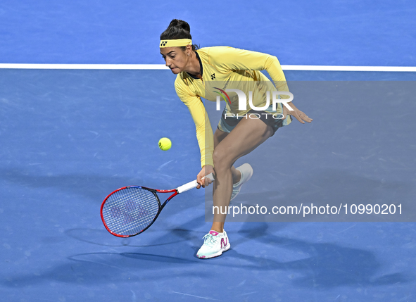 Caroline Garcia of France is in action during her first-round match against Naomi Osaka of Japan at the WTA 1000-Qatar TotalEnergies Open te...