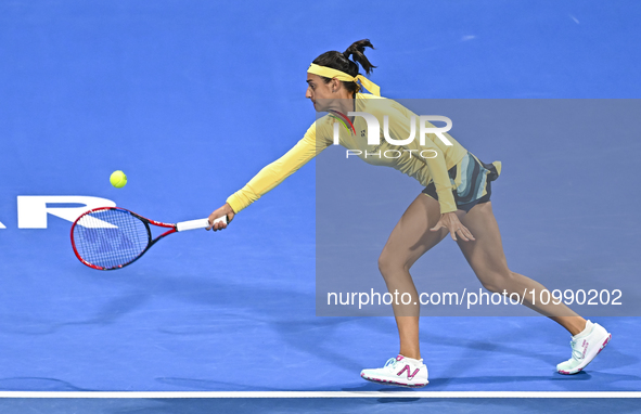 Caroline Garcia of France is in action during her first-round match against Naomi Osaka of Japan at the WTA 1000-Qatar TotalEnergies Open te...