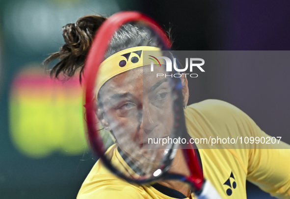 Caroline Garcia of France is in action during her first-round match against Naomi Osaka of Japan at the WTA 1000-Qatar TotalEnergies Open te...