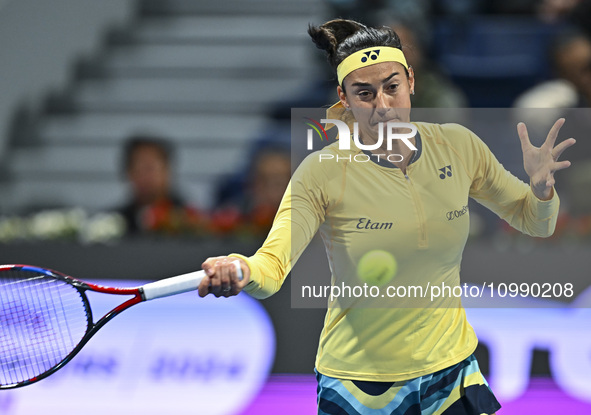 Caroline Garcia of France is in action during her first-round match against Naomi Osaka of Japan at the WTA 1000-Qatar TotalEnergies Open te...