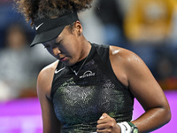 Naomi Osaka of Japan is reacting during her first-round match against Caroline Garcia of France at the WTA 1000-Qatar TotalEnergies Open ten...