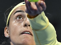 Caroline Garcia of France is in action during her first-round match against Naomi Osaka of Japan at the WTA 1000-Qatar TotalEnergies Open te...