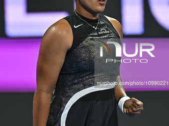 Naomi Osaka of Japan is reacting during her first-round match against Caroline Garcia of France at the WTA 1000-Qatar TotalEnergies Open ten...