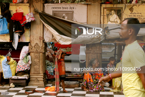 A homeless child is with an elderly woman at the transient roadside settlements in Kolkata, India, on February 12, 2024. 