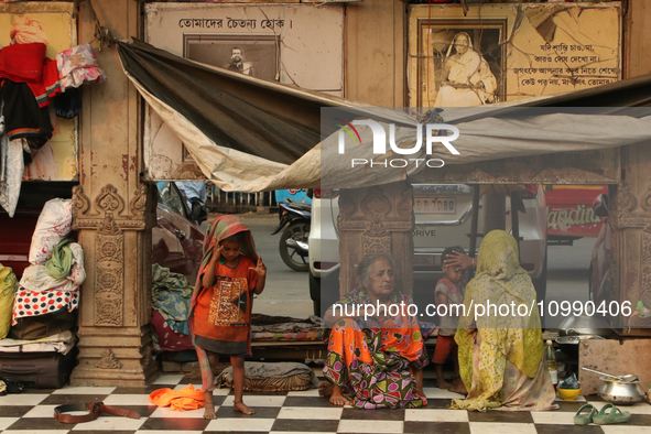 A homeless child is with an elderly woman at the transient roadside settlements in Kolkata, India, on February 12, 2024. 