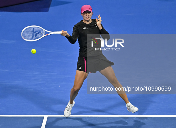 Iga Swiatek of Poland is playing in her second-round match against Sorana Cirstea of Romania at the WTA 1000-Qatar TotalEnergies Open tennis...