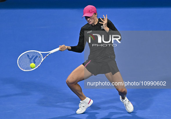 Iga Swiatek of Poland is playing in her second-round match against Sorana Cirstea of Romania at the WTA 1000-Qatar TotalEnergies Open tennis...