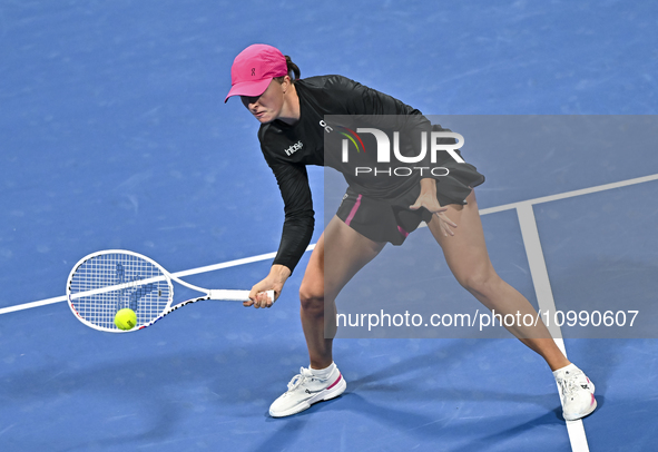 Iga Swiatek of Poland is playing in her second-round match against Sorana Cirstea of Romania at the WTA 1000-Qatar TotalEnergies Open tennis...