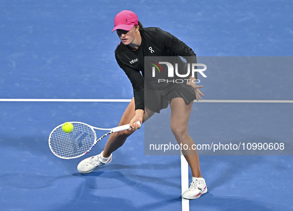 Iga Swiatek of Poland is playing in her second-round match against Sorana Cirstea of Romania at the WTA 1000-Qatar TotalEnergies Open tennis...