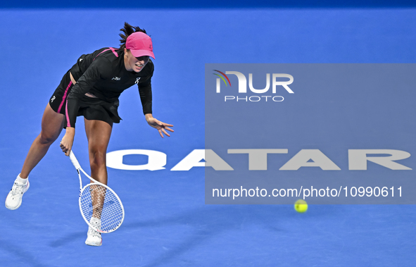 Iga Swiatek of Poland is playing in her second-round match against Sorana Cirstea of Romania at the WTA 1000-Qatar TotalEnergies Open tennis...