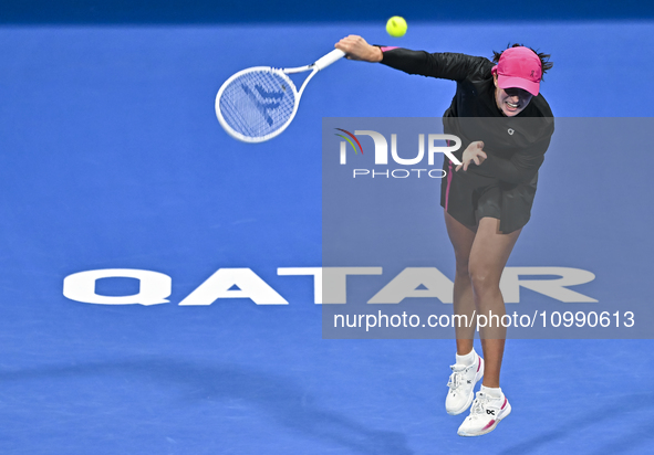 Iga Swiatek of Poland is playing in her second-round match against Sorana Cirstea of Romania at the WTA 1000-Qatar TotalEnergies Open tennis...