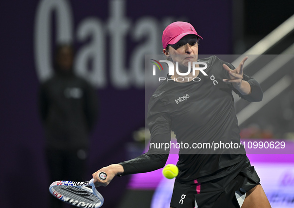 Iga Swiatek of Poland is playing in her second-round match against Sorana Cirstea of Romania at the WTA 1000-Qatar TotalEnergies Open tennis...