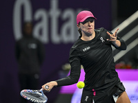 Iga Swiatek of Poland is playing in her second-round match against Sorana Cirstea of Romania at the WTA 1000-Qatar TotalEnergies Open tennis...